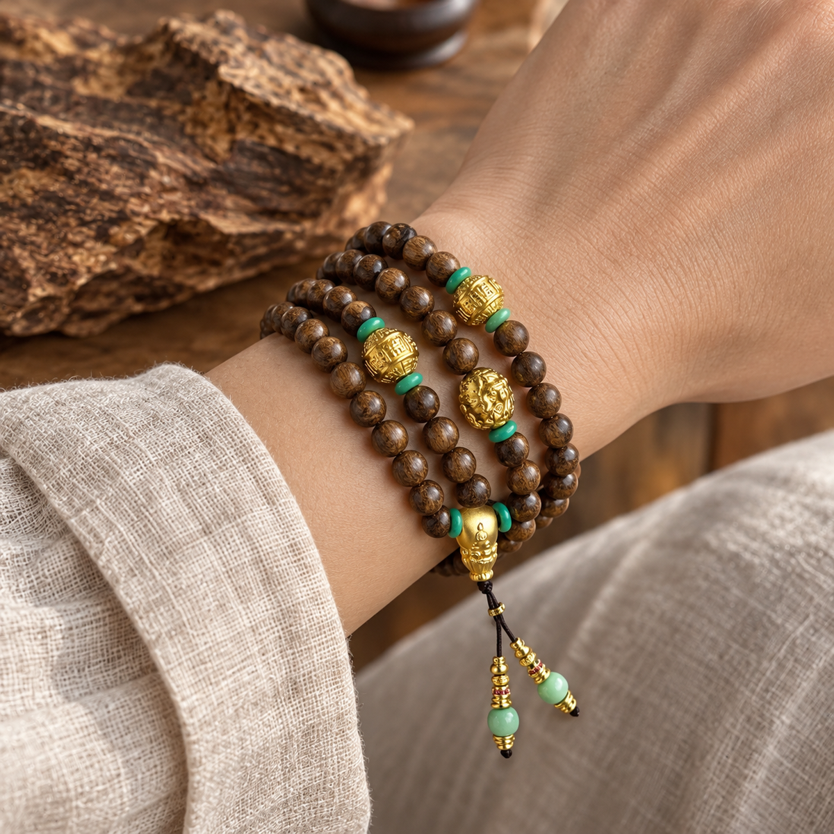 108-Bead Wood Mala with Gold Guru Bead - 04_scene_wrist_agarwood